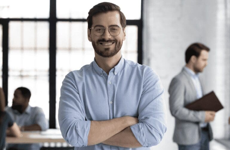 Smiling man in blue shirt and glasses