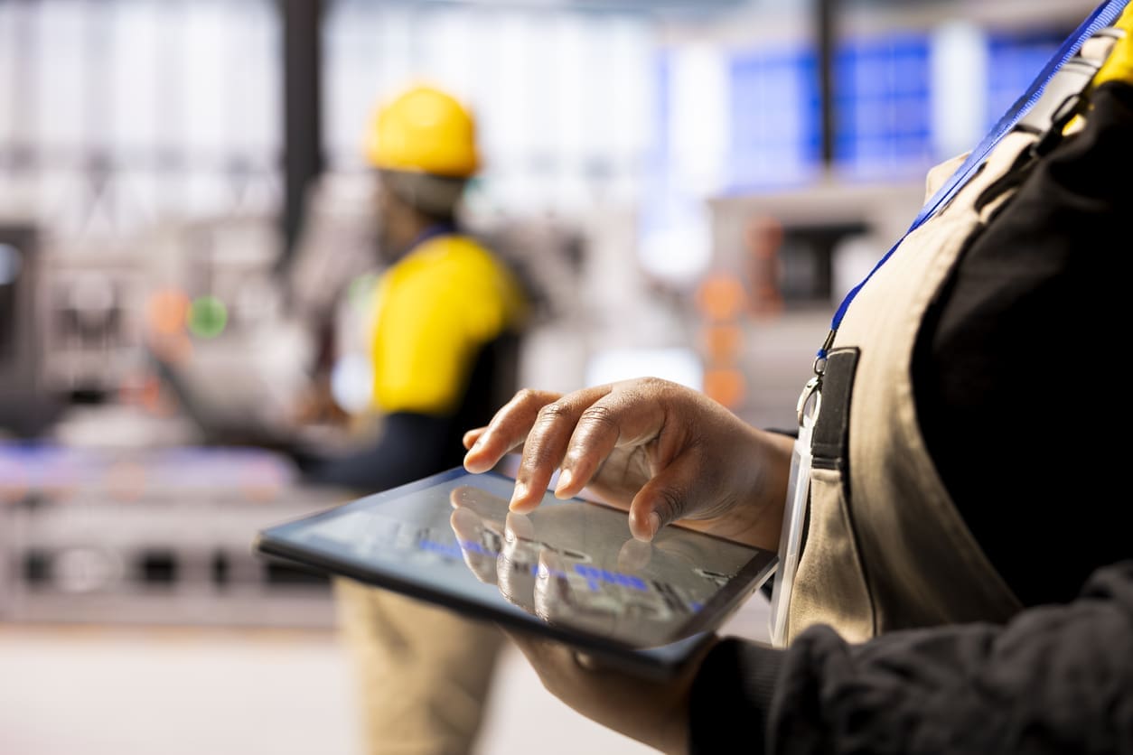 Person using tablet in industrial setting